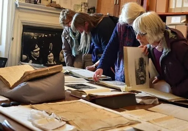 Members and guests viewing items from the archives