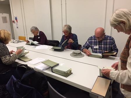 Members of the group look at archival materials at the Royal Highland and Agricultural Society of Scotland.