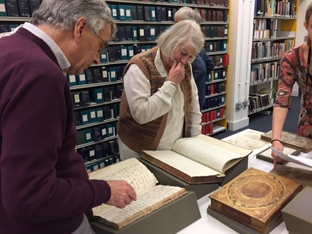 Members of the group look at archival materials at the Royal Highland and Agricultural Society of Scotland.