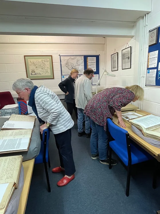 Members of the group looking at archived materials